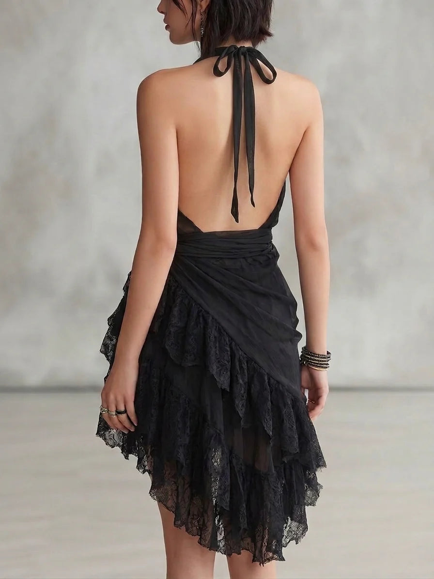 Back view of the black A-line halter dress, showing the ruffled asymmetrical hem.