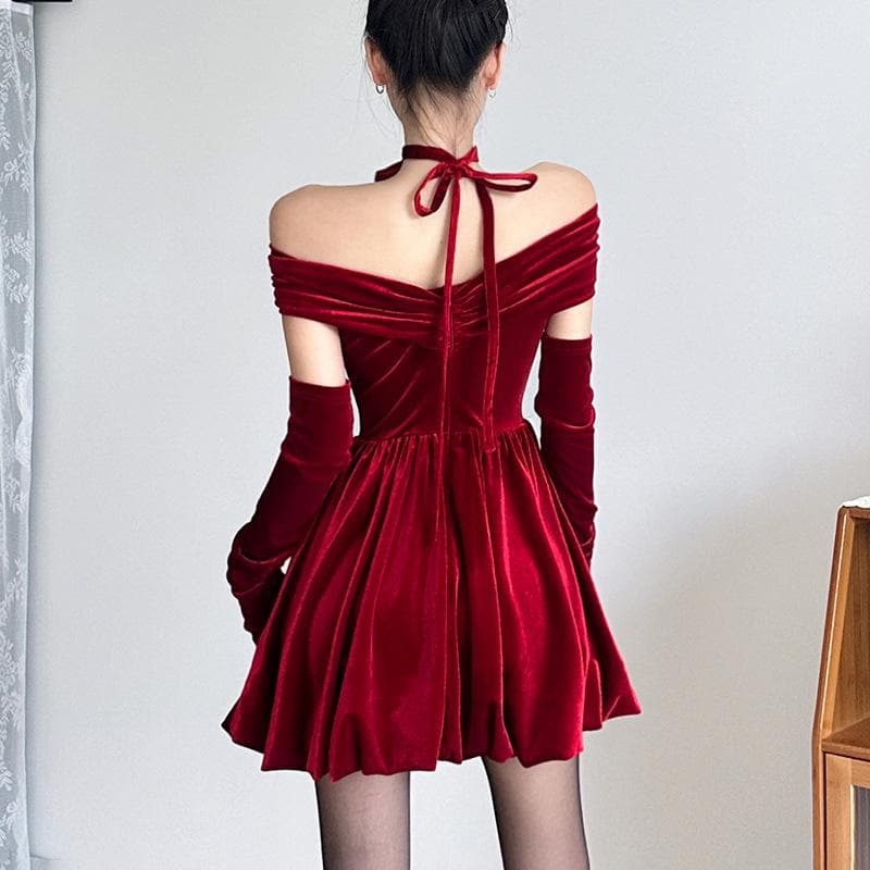 Model wearing a burgundy velvet off-shoulder ruched A-line mini dress, side view.