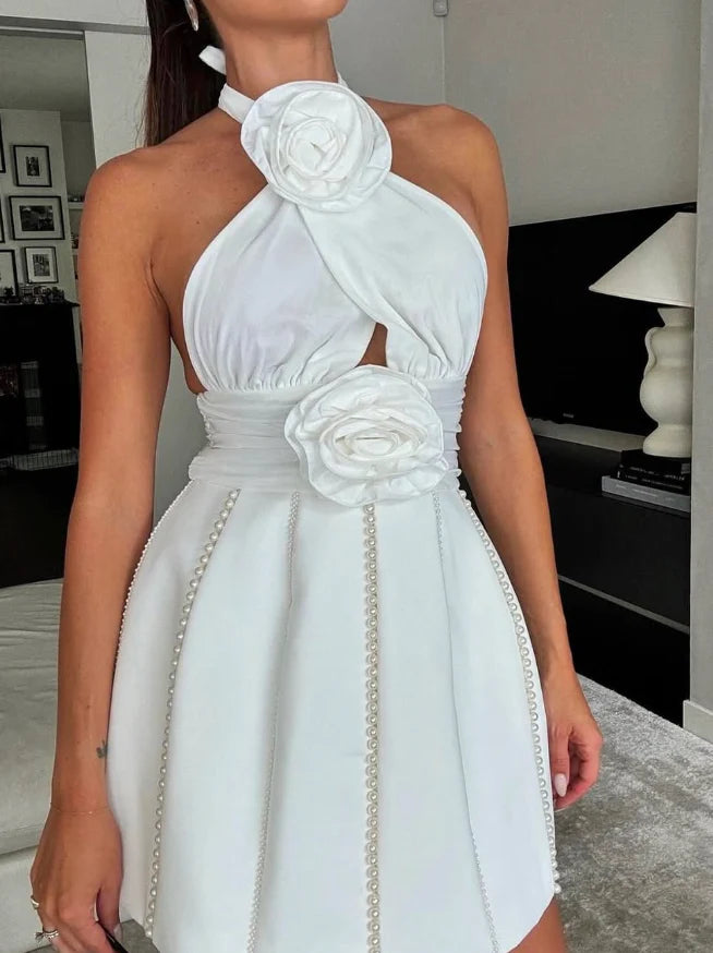 Front view of a model wearing a short halter A-line satin dress with 3D floral and pearl embellishments.