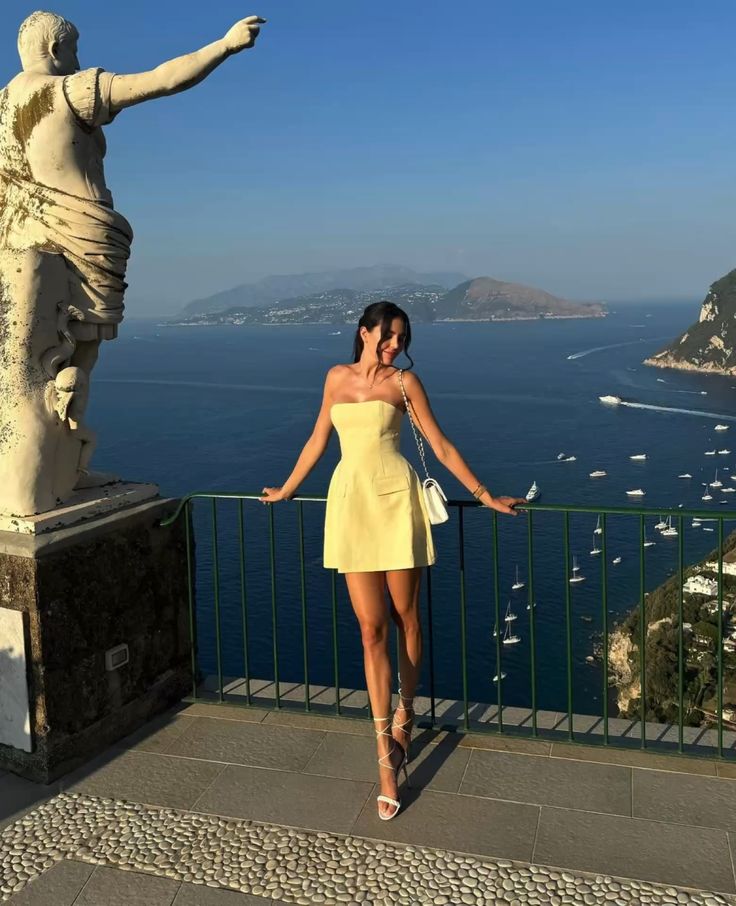 Woman wearing a charming yellow satin A-line mini homecoming dress.