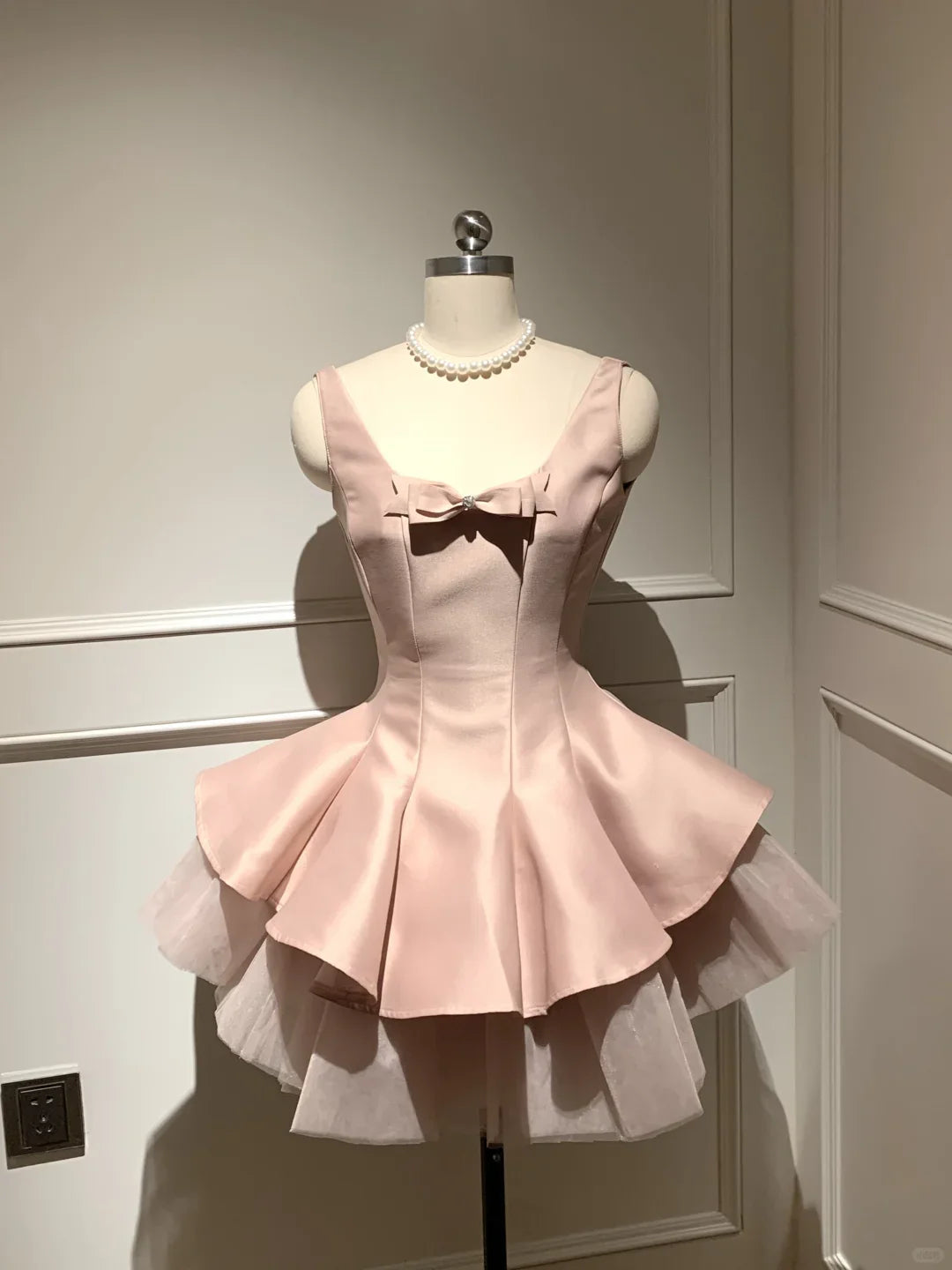Back view of light pink short homecoming dress showing bow.