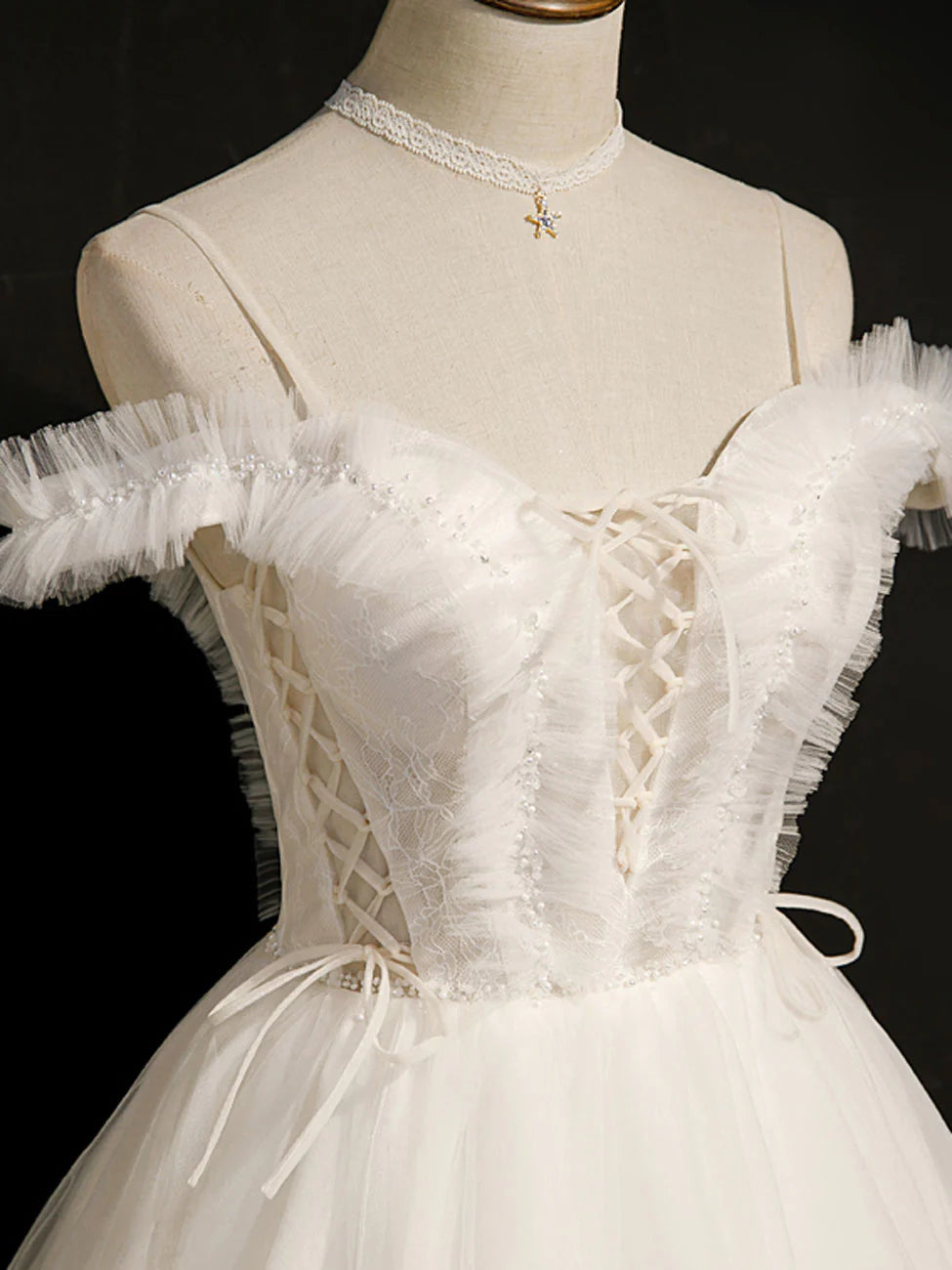 Side view of a model in a white short puffy prom dress with a sweetheart neckline.