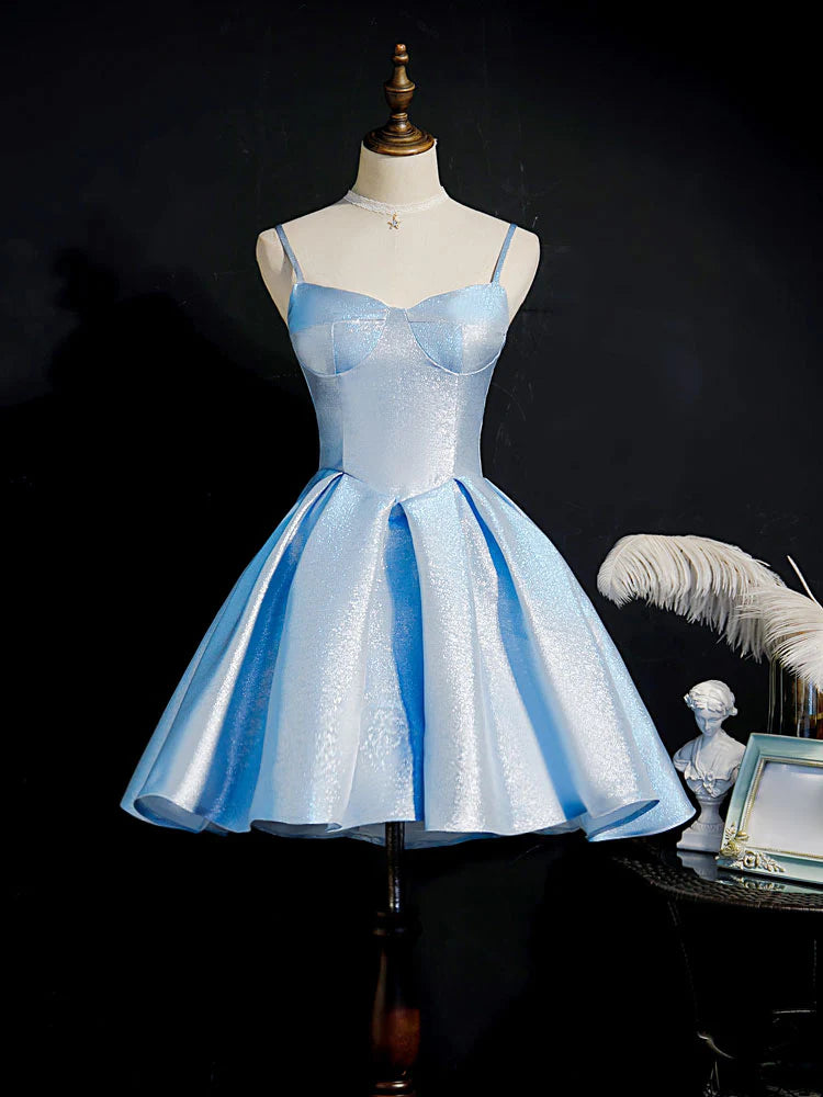 Model in a blue sweetheart neck short prom dress, front view.