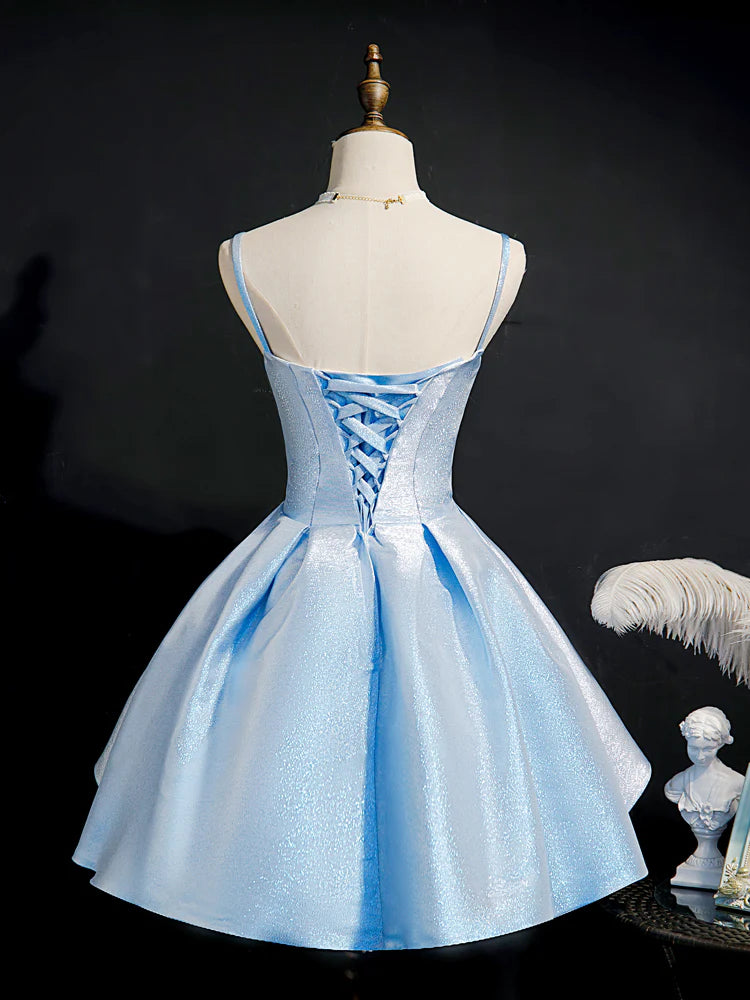 Model in a blue sweetheart neck short homecoming dress, side view.