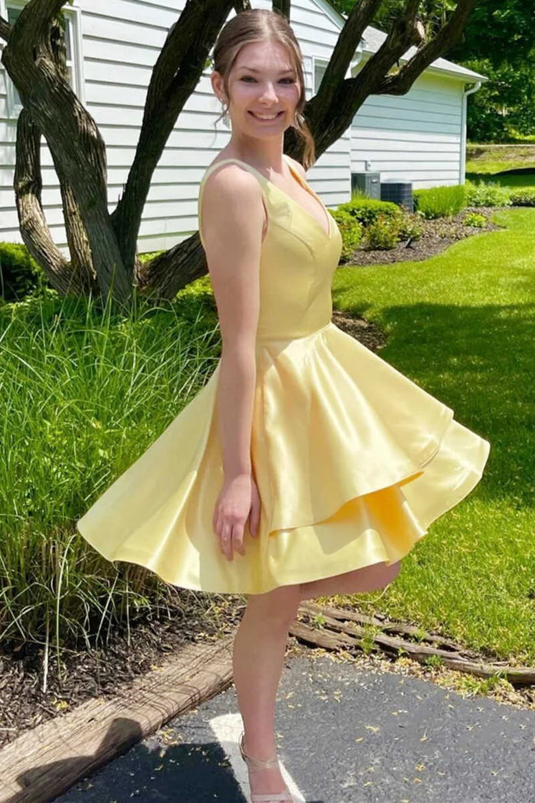 Front view of a woman wearing a yellow A-line V-neck short homecoming dress.