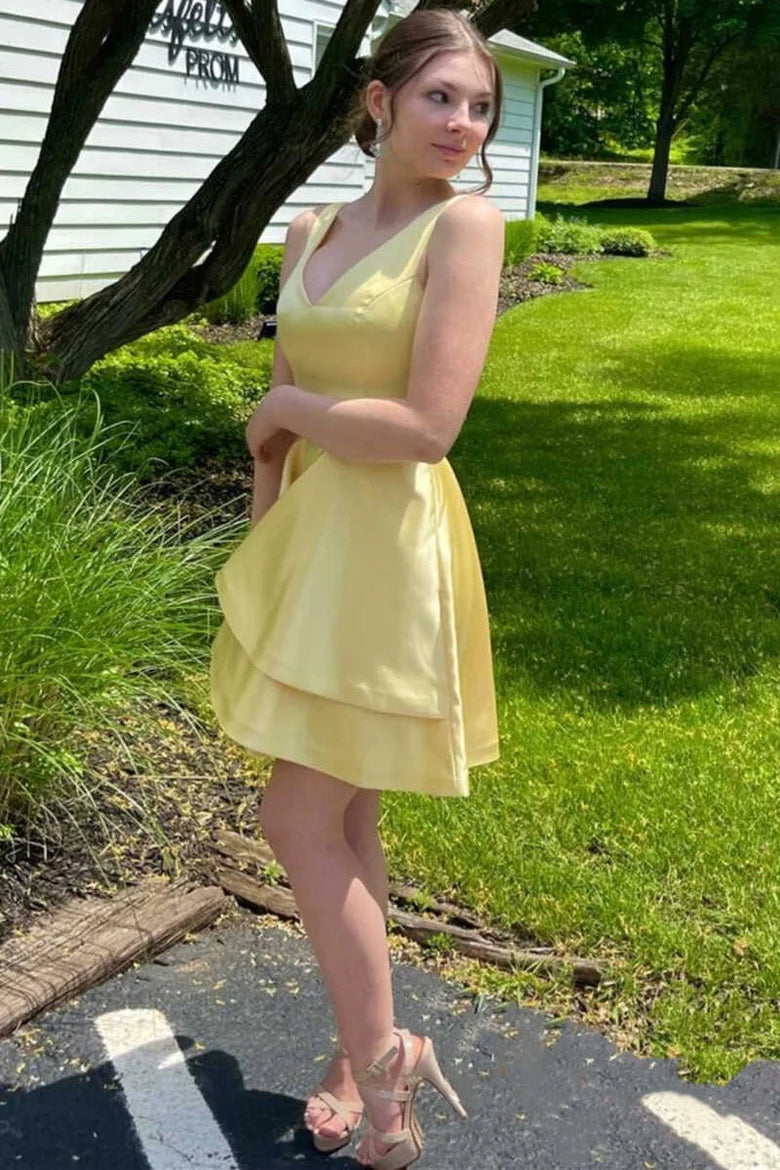 Side view of a woman in a yellow A-line double layer party dress.