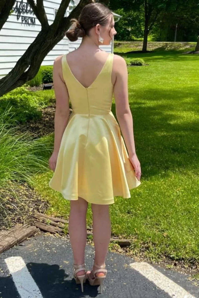 Back view of a woman in a yellow V-neck short formal dress.
