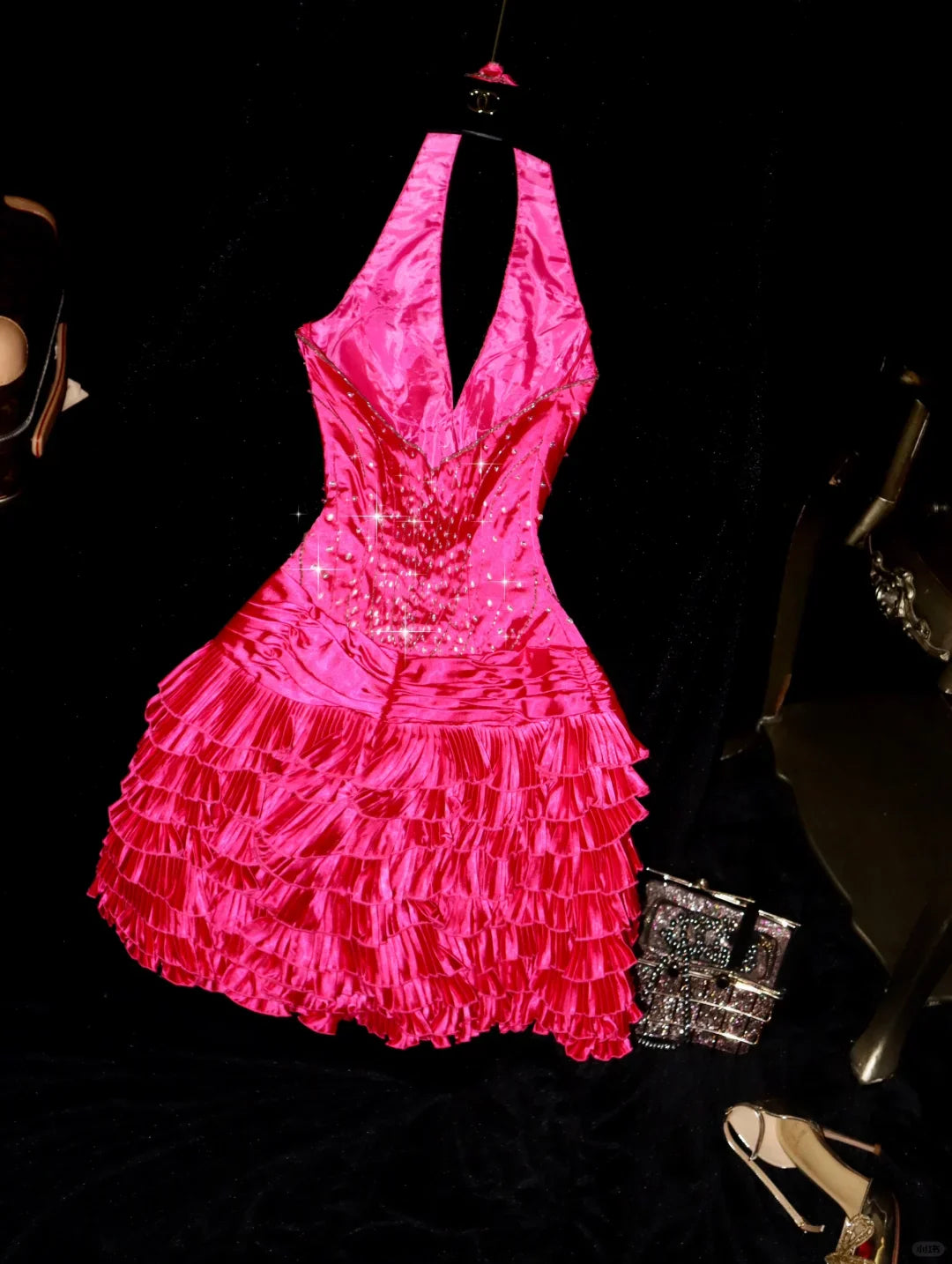 Close-up of the Barbie pink A-line halter dress, showcasing the layered satin and beaded embellishments.