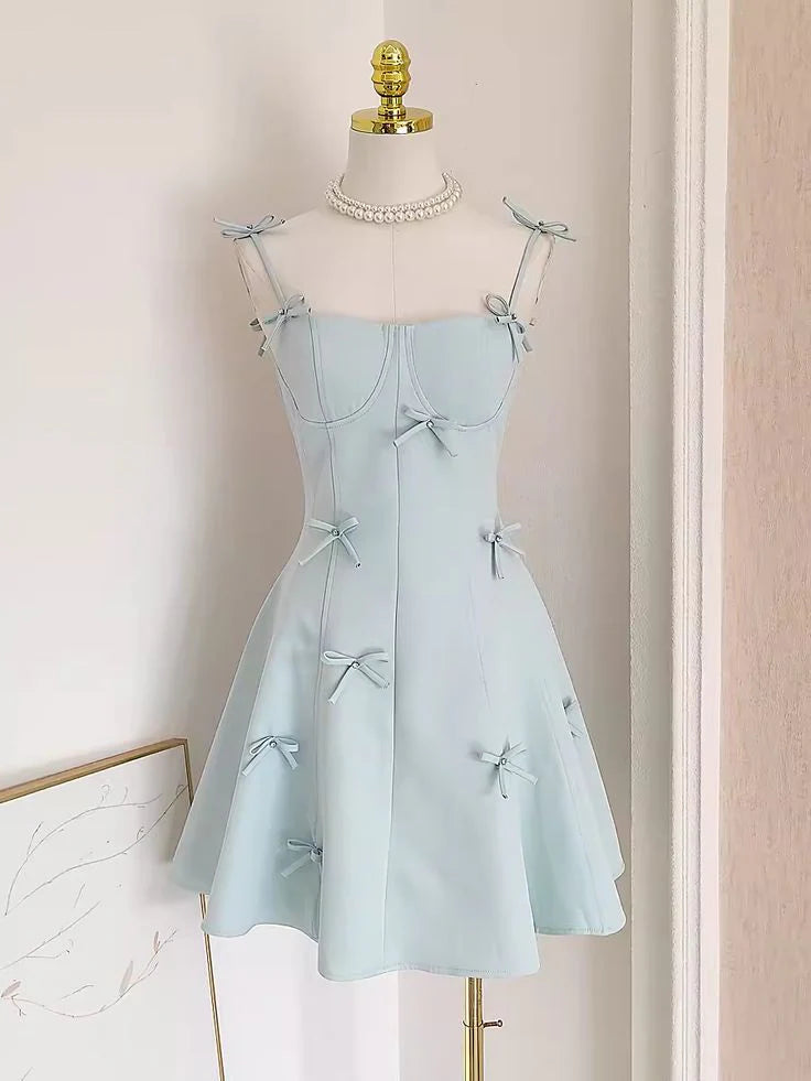 Woman wearing a chic A-line spaghetti strap short dress.