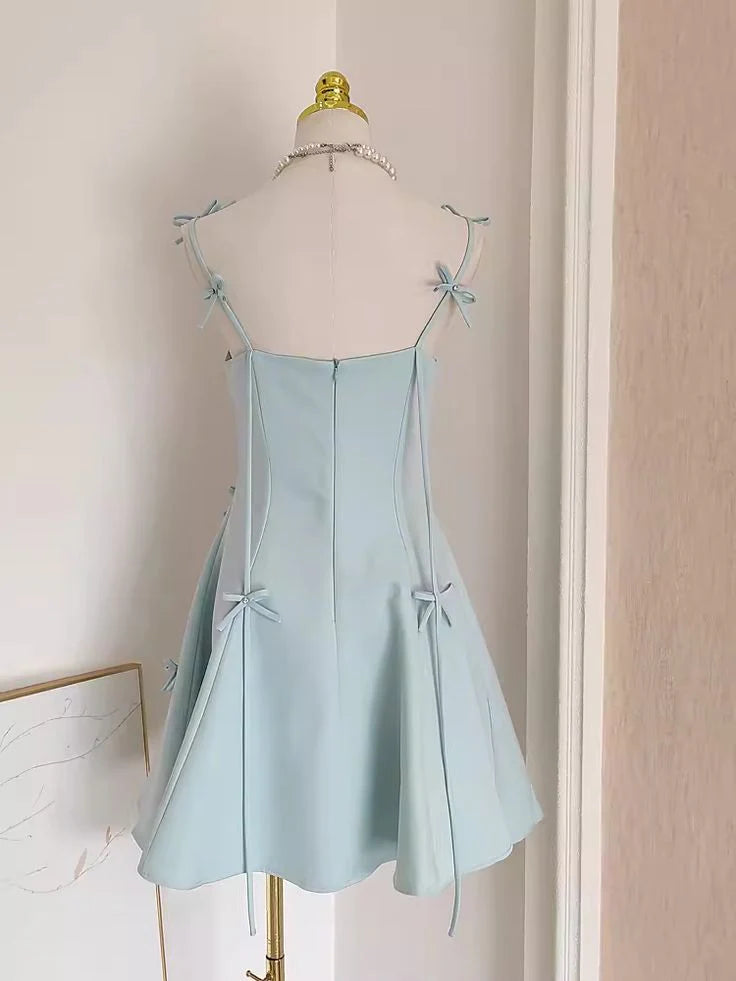 Back view of a woman in an A-line spaghetti strap dress.