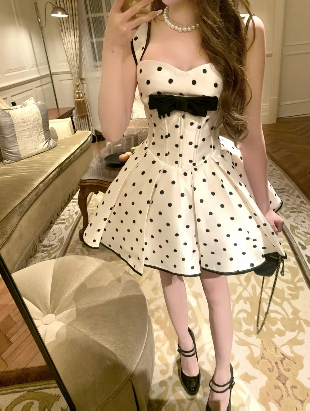 Full length view of a woman posing in a white short homecoming dress.