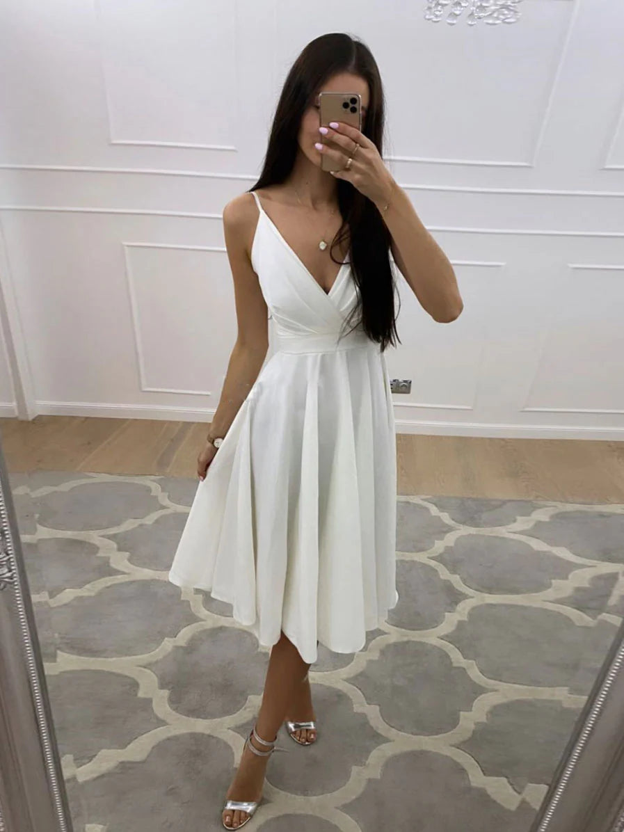 Woman wearing a chic short white V-neck A-line prom dress.