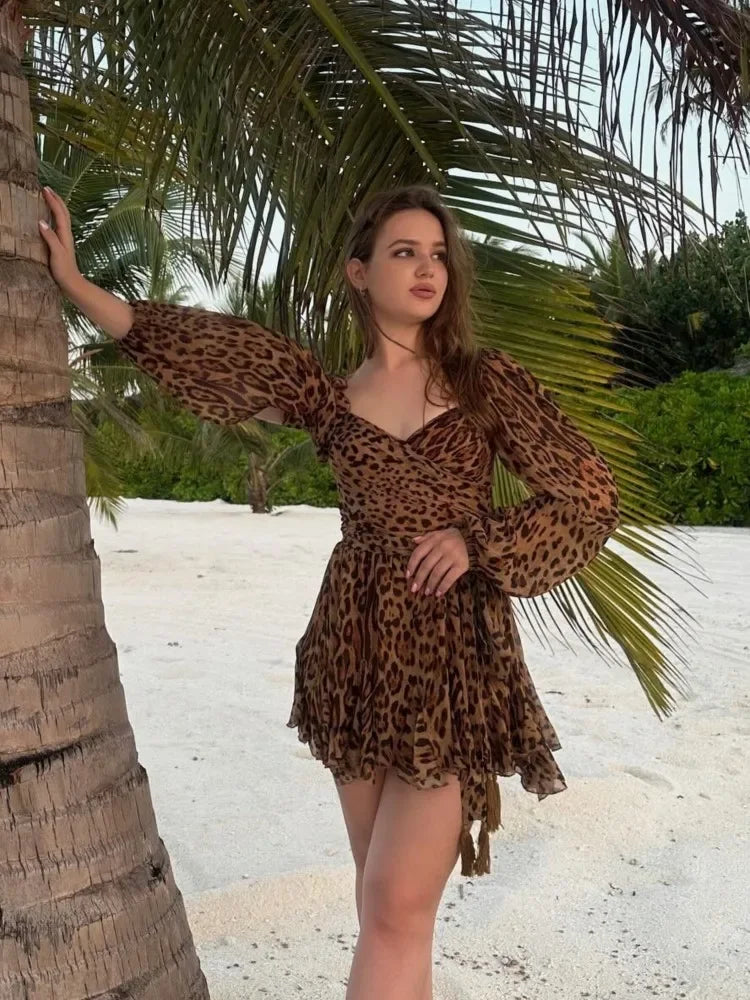 Back view of the A-line leopard chiffon short dress, showing the long sleeves and flowing fabric.