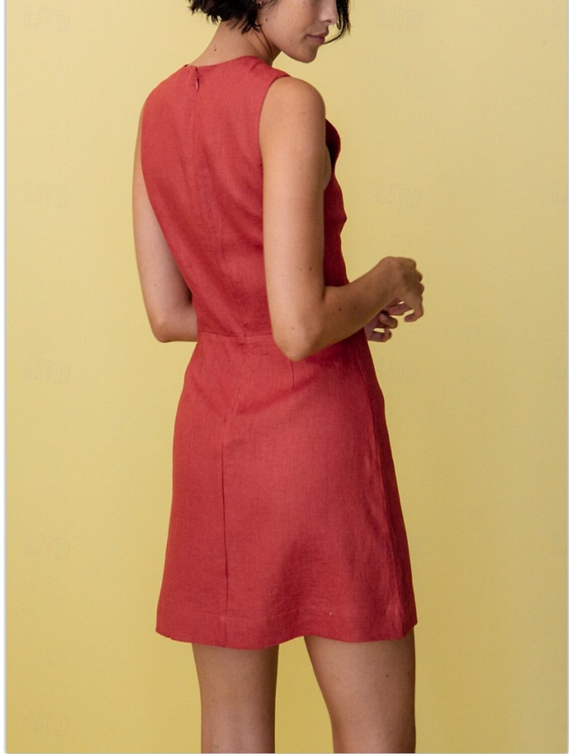 Back view of a woman in a pure color A-line V-neck sleeveless mini dress.