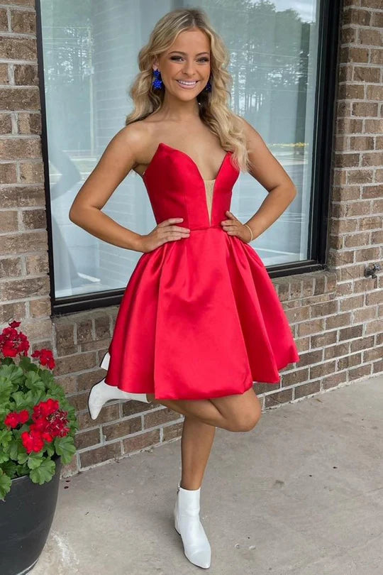 Side view of a model in a red strapless A-line dress, highlighting the gathered skirt.