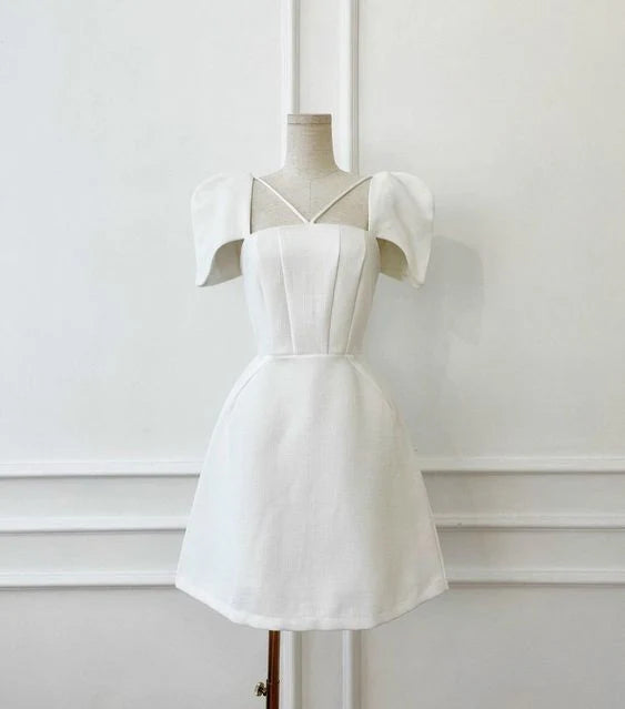 Model wearing a chic white satin short prom dress with short sleeves and V-neck.