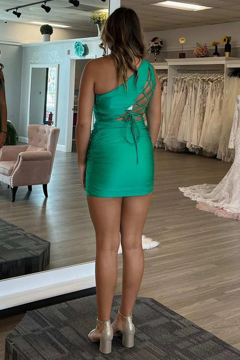 Side view of woman in green one-shoulder bodycon mini dress, showcasing lace-up detail.