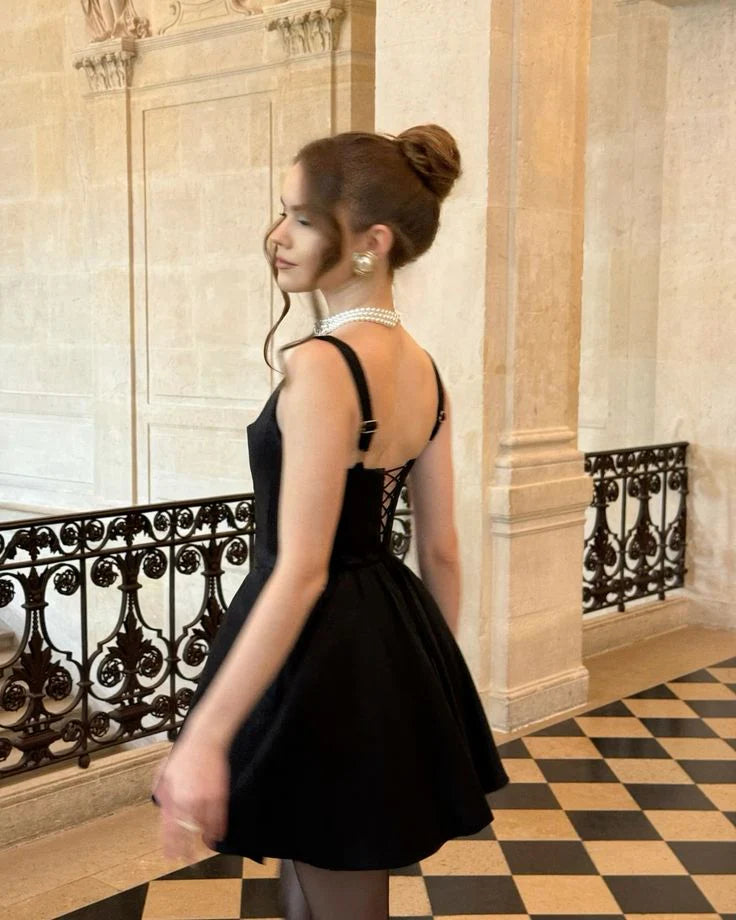 Elegant black square neck mini dress with a flattering bodycon fit.
