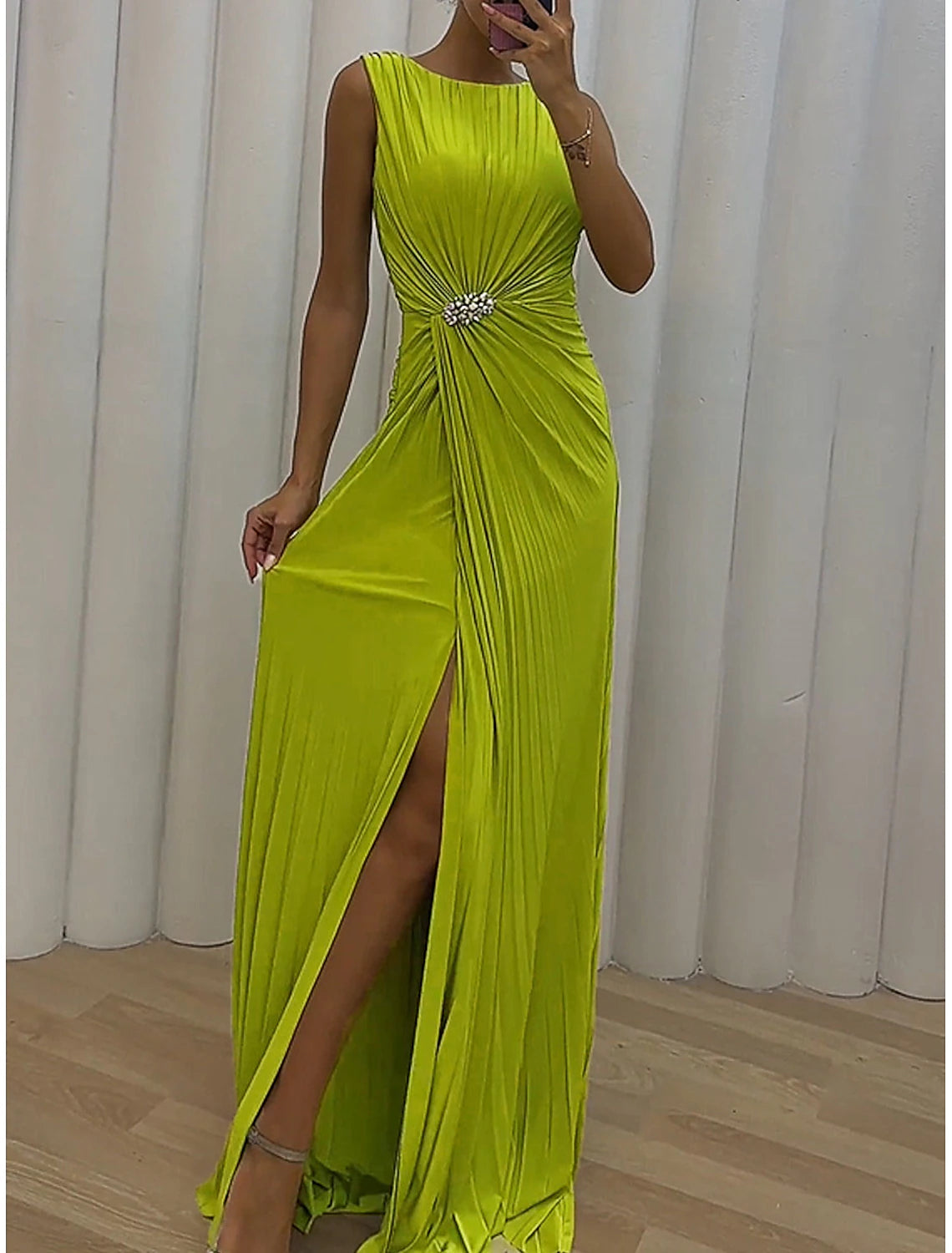 Model wearing a green split crew neck sleeveless A-line prom dress.