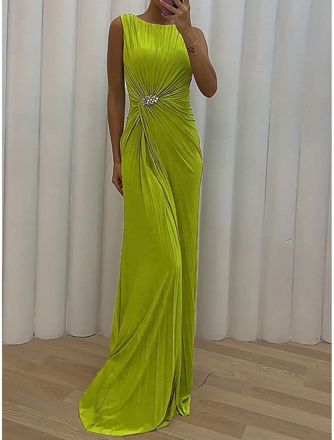 Full view of a model showcasing the elegant green prom dress.