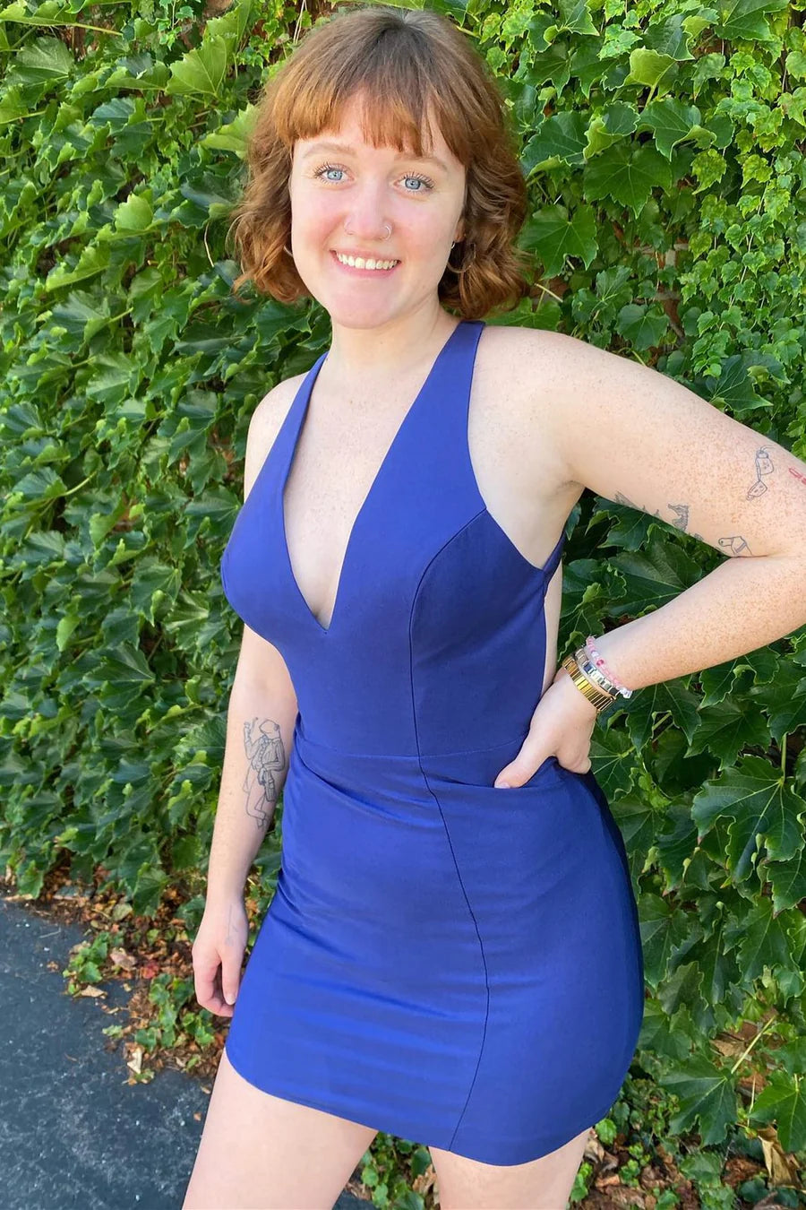 Model wearing a chic dark halter bodycon short homecoming dress.