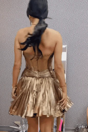 Back view of a metallic pleated A-line short homecoming dress, showcasing the empire-waist.