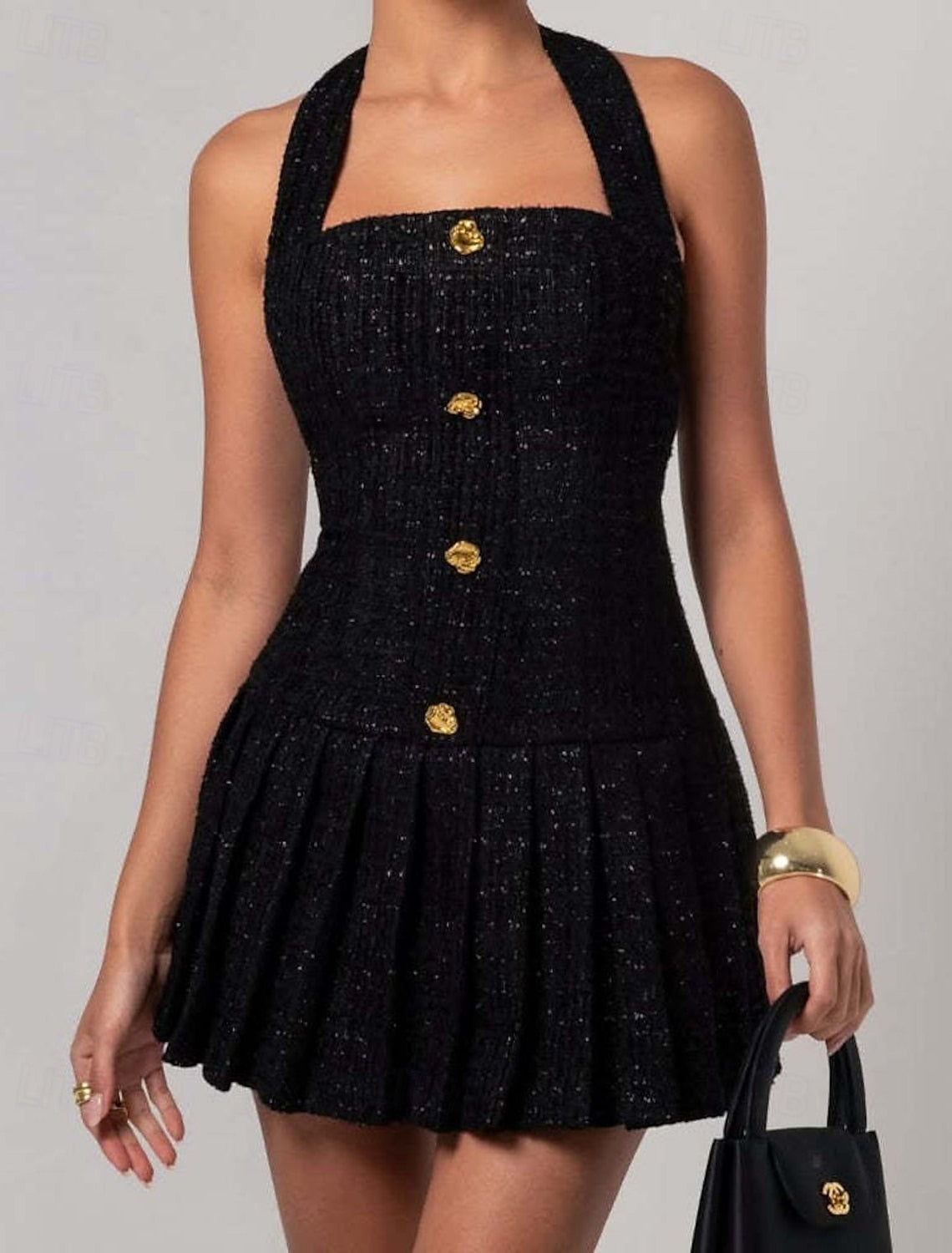Woman posing in a black regular fit halter neck party dress.