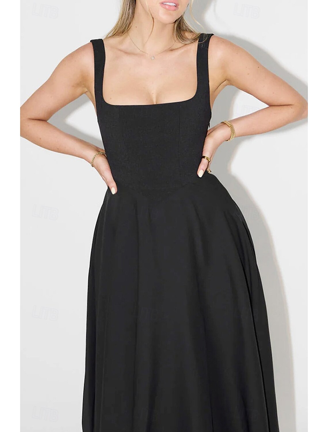 Woman wearing a chic white spaghetti strap slip midi dress.