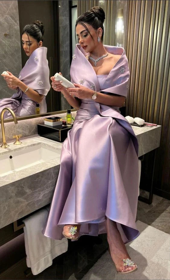 Side view of the two-piece satin evening dress, showing the flowing skirt.