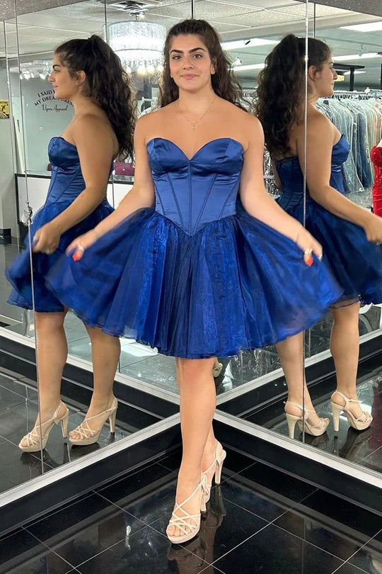 Close-up of the princess-seamed bodice on a blue strapless homecoming dress.