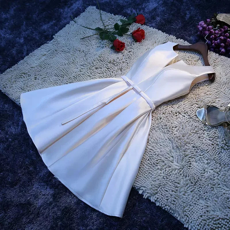 Side view of the satin mini dress, highlighting the waist-cinching detail.