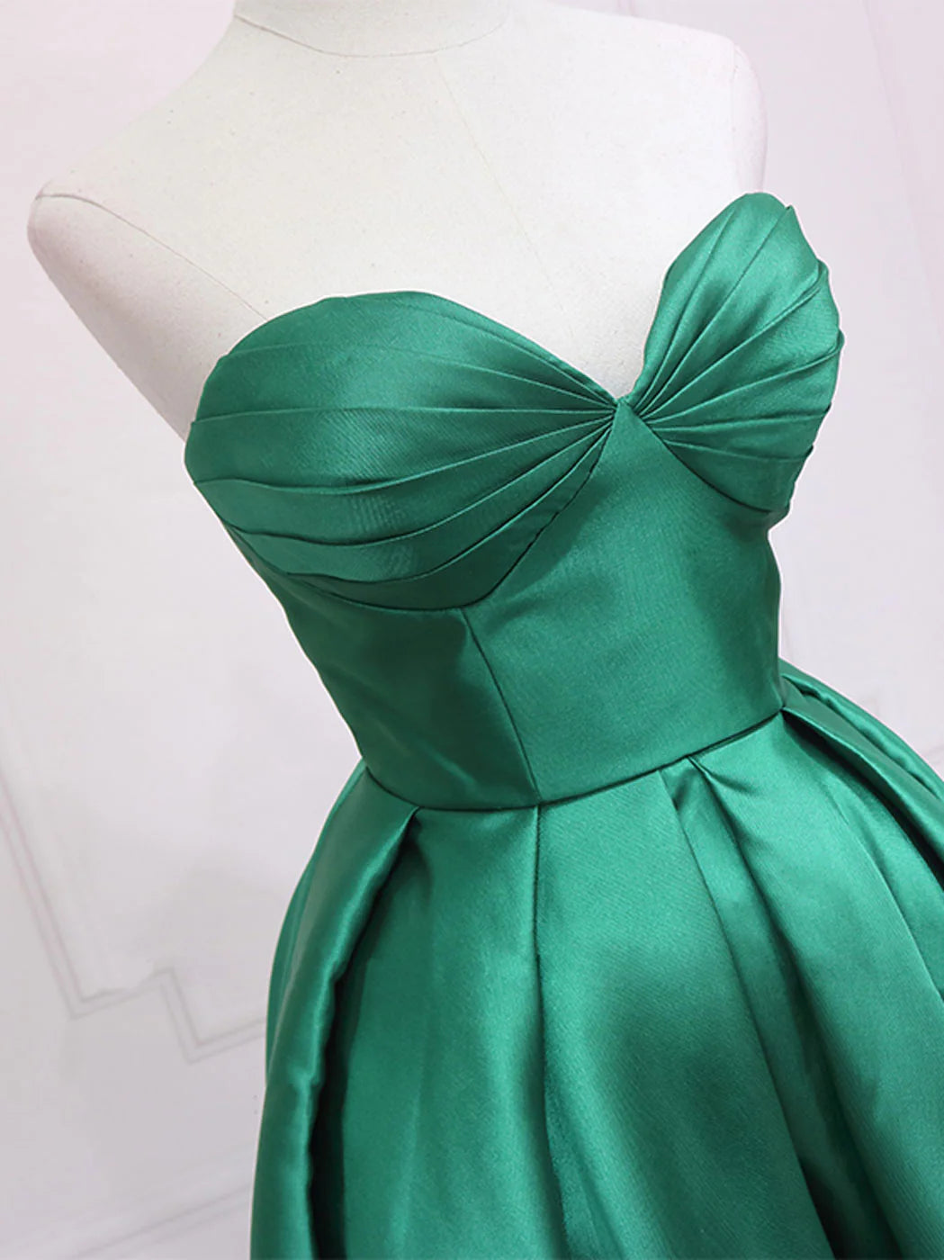 Back view of a green sweetheart neck high-low formal dress.