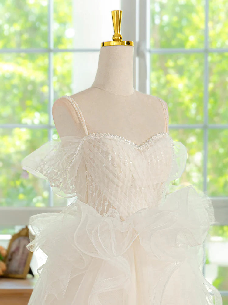 Side profile of the ivory short ball gown, highlighting the voluminous tulle skirt.