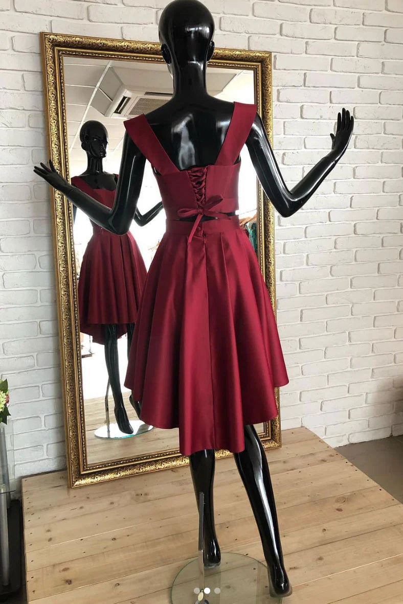 Model wearing a chic burgundy two-piece short homecoming dress, side view.