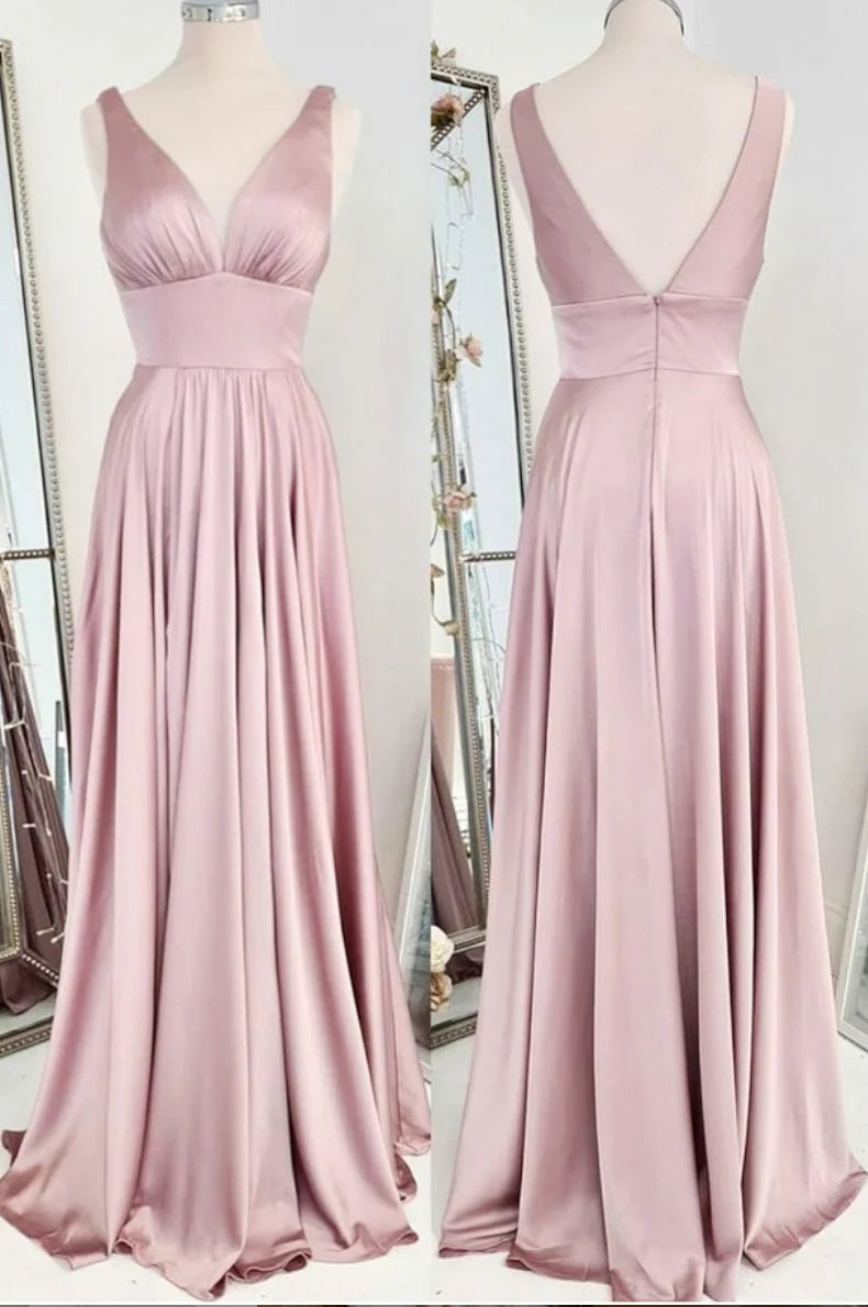 Woman wearing a pink satin V-neck backless long prom dress.