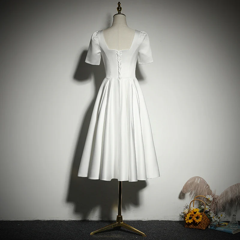 Side view of the elegant white A-line short evening dress.