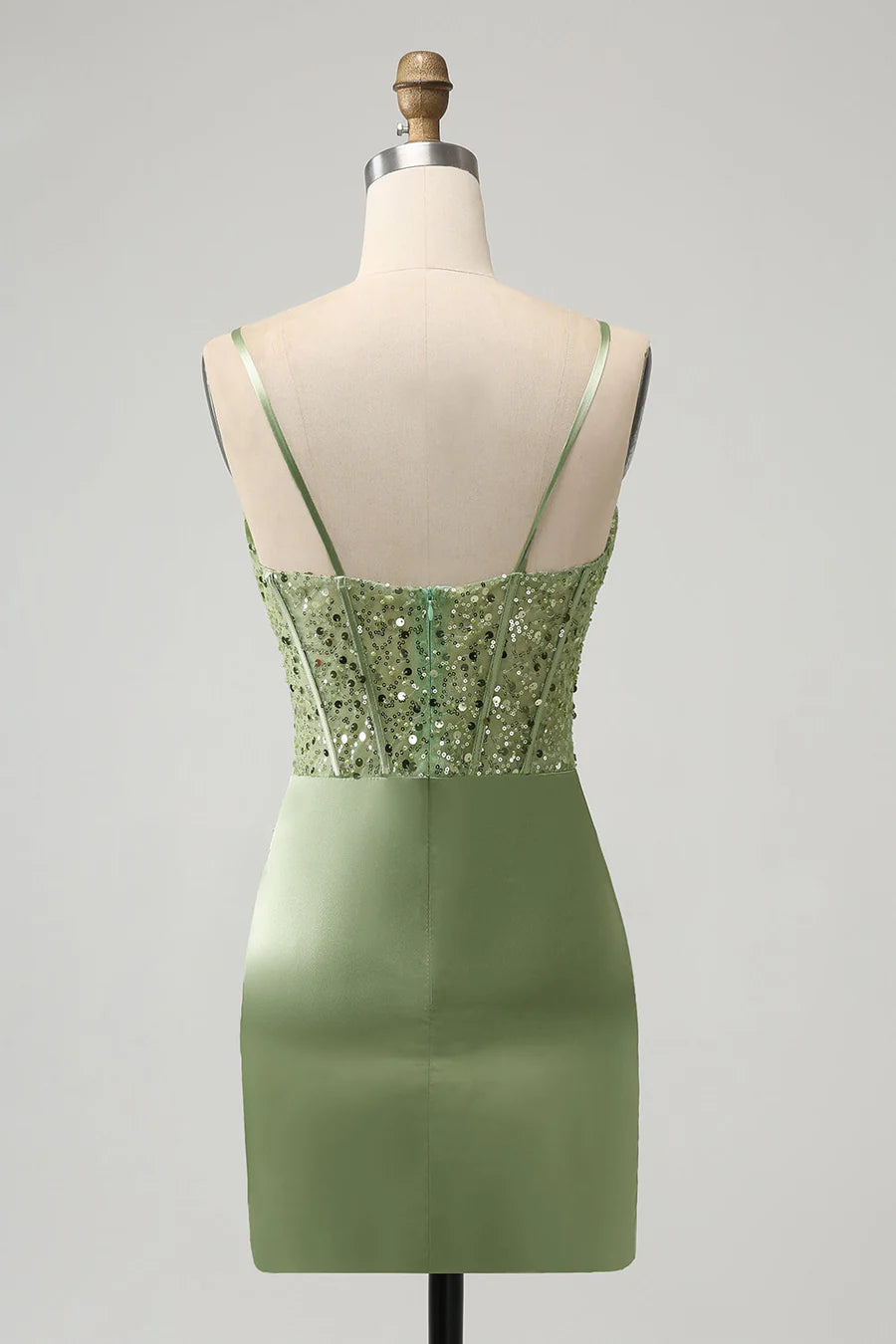 Back view of a model in a sage green sequin mini dress, highlighting the delicate spaghetti straps.