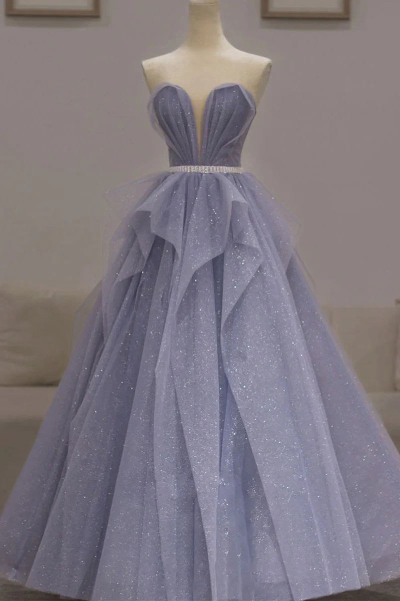 Model in a dazzling purple sequin off-shoulder long prom dress, front view.