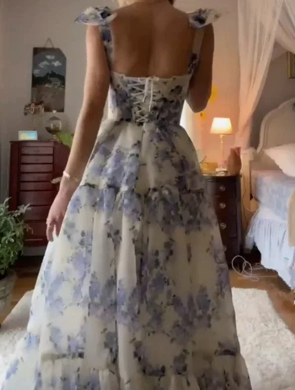 Close-up of the sweetheart neckline and blue floral print on the prom dress.