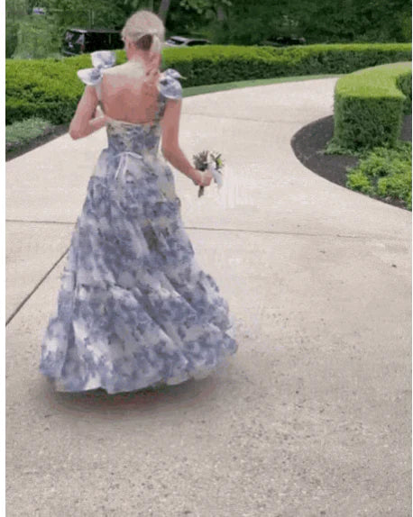Back view of the blue floral prom dress, highlighting the lace-up detail.