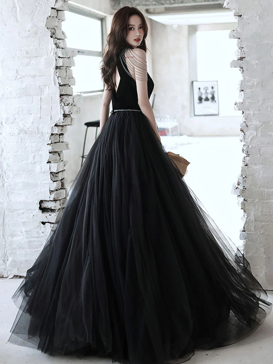 Back view of a model in the black A-line beaded evening gown.