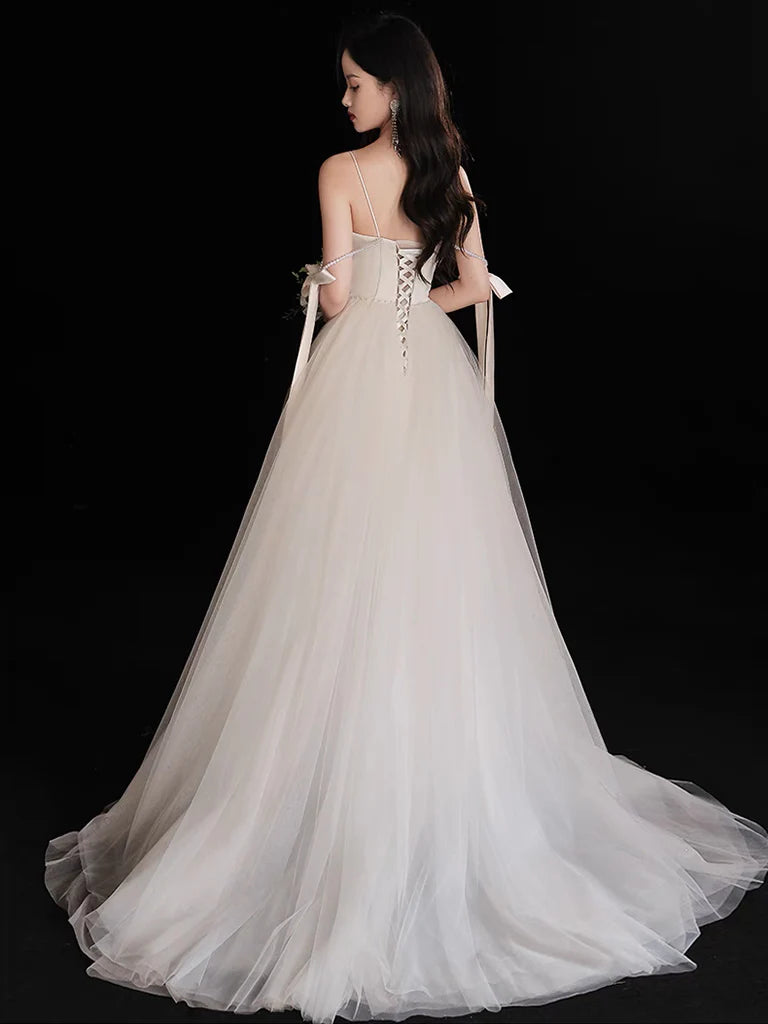 Close-up of the beaded bodice and tulle fabric of the light champagne evening gown.