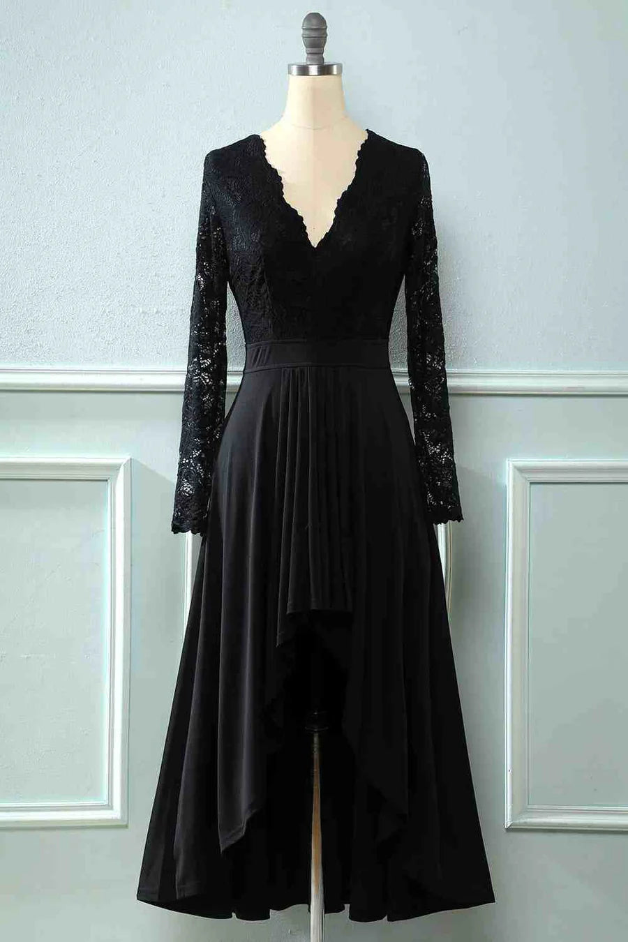 Woman wearing an elegant black lace long sleeve V-neck Mother of the Groom dress.