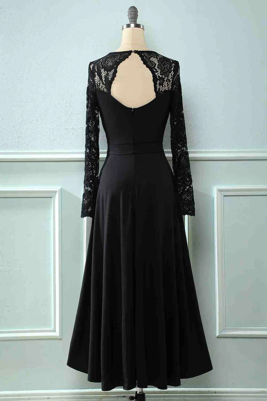 Side view of the black lace long sleeve dress, showing the flowing skirt.