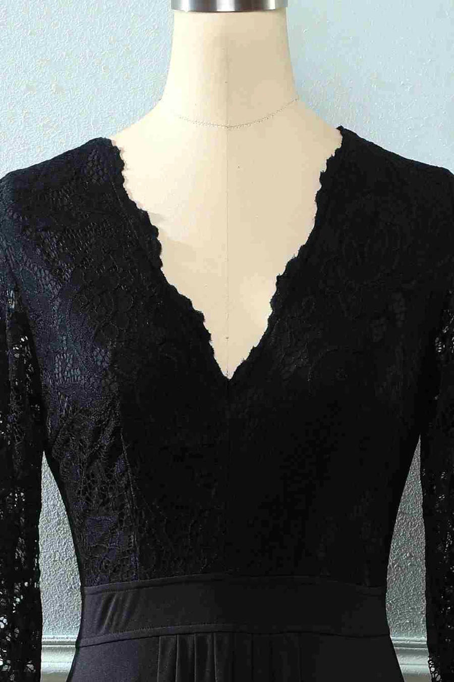 Back view of the black lace gown, highlighting the open back design.