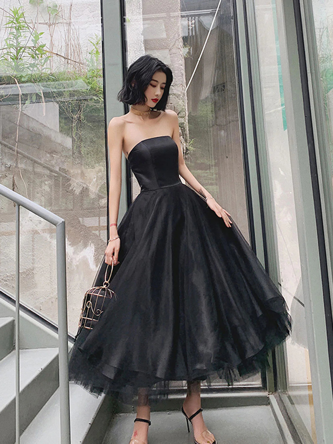 Elegant black tea-length tulle prom dress with A-line silhouette, front view.
