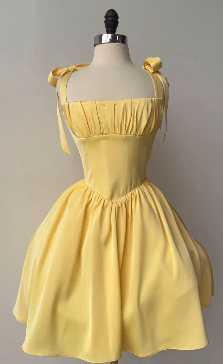 Elegant yellow A-line prom gown with bow straps, front view.
