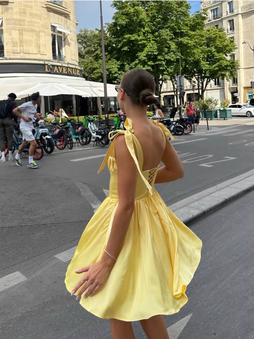 Yellow bow-strap formal gown, side view on model.