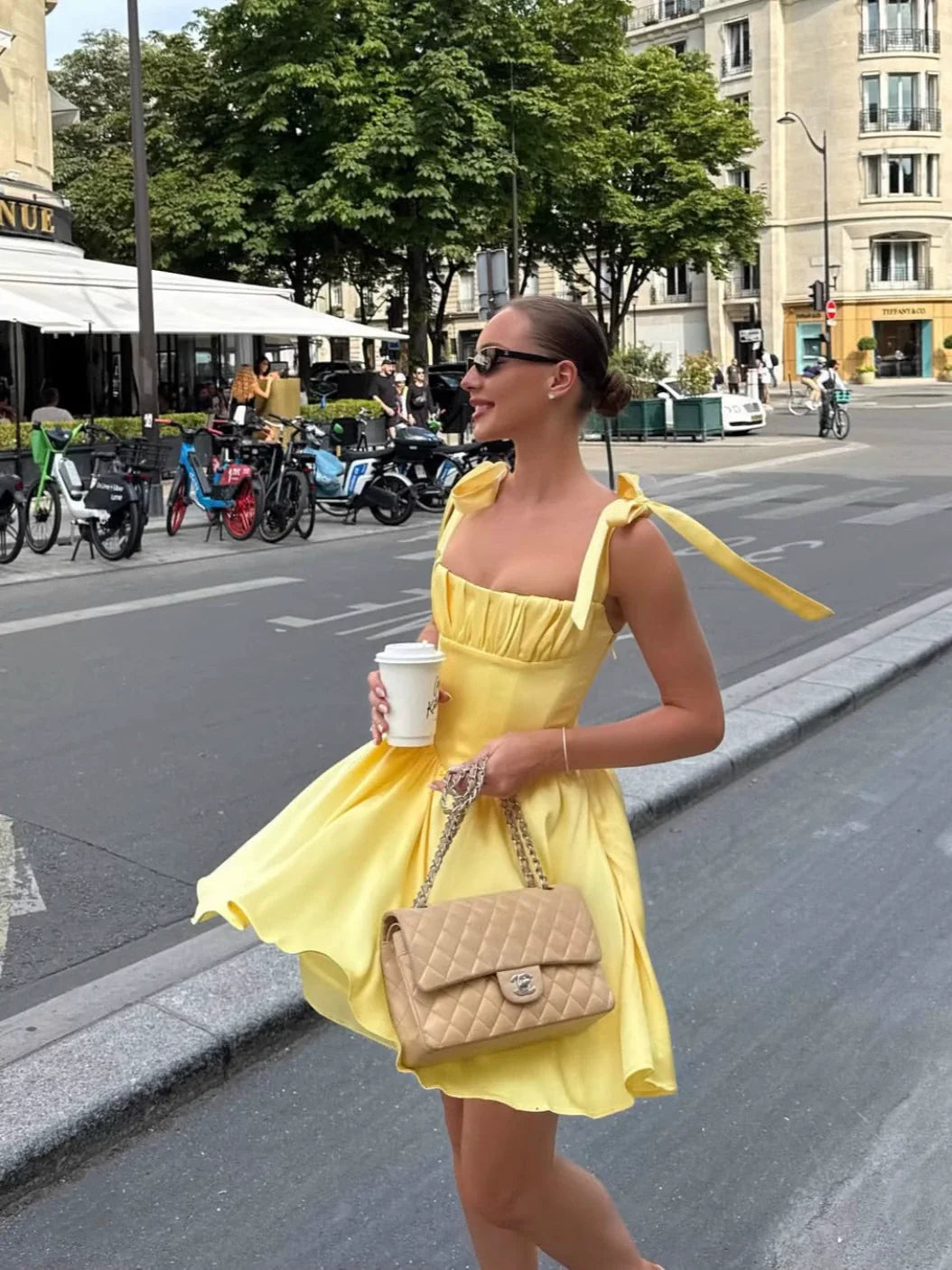 Close-up of the bow-strap detail on a yellow formal dress.
