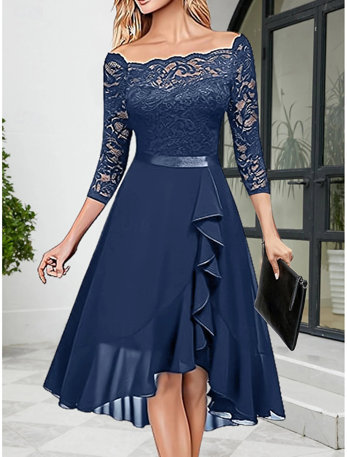 Full-length view of a woman wearing an elegant blue half-sleeve lace party dress.